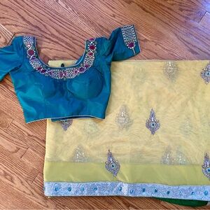 Beautiful yellow net saree with crystal motifs and sequin border